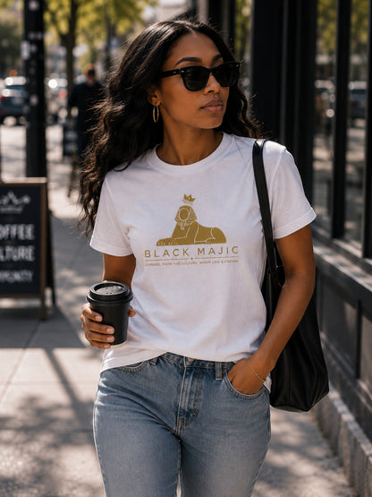 Black woman wearing the BLACK MAJIC Crown Graphic Tee in white, filled gold crowned Sphinx over the wordmark