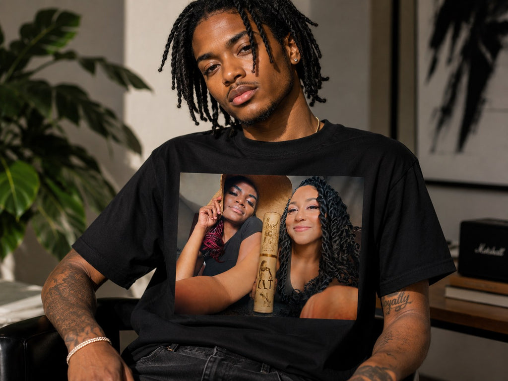 Velvet Ritual Session Tee in black, worn — two queens with the gold Egyptian scroll printed across the chest