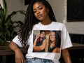 Velvet Ritual Session Tee in white, worn — two queens with the gold Egyptian scroll printed across the chest