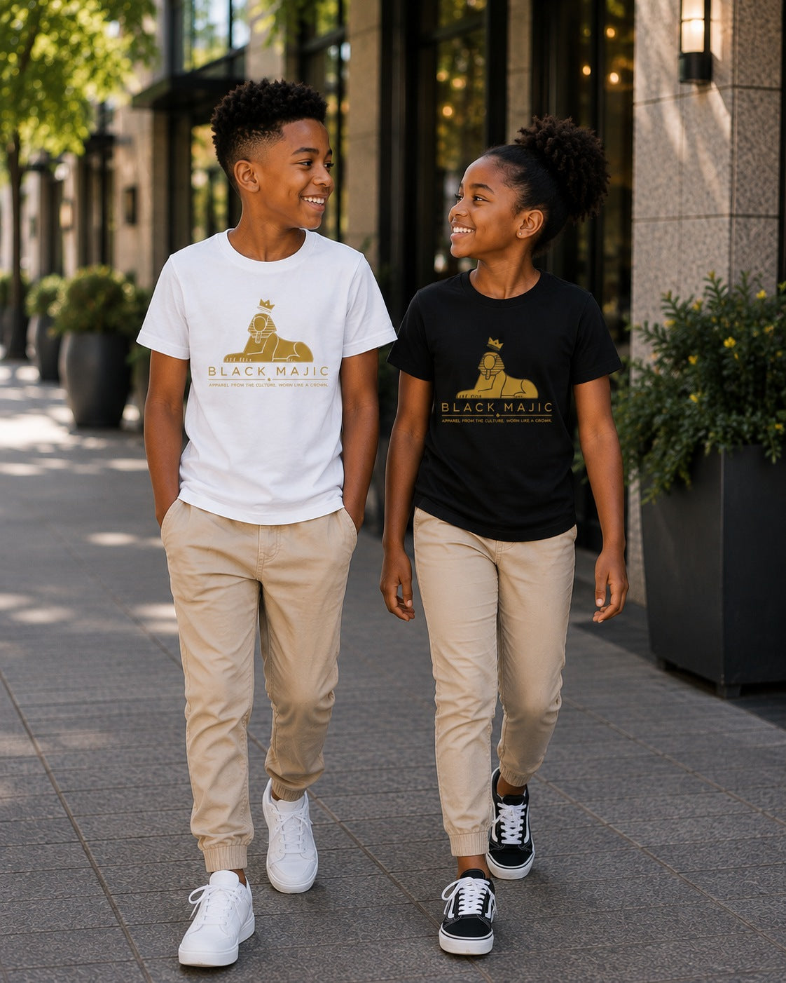 Boy in the black BLACK MAJIC Kids Crown Graphic Tee walking with his father in the white tee