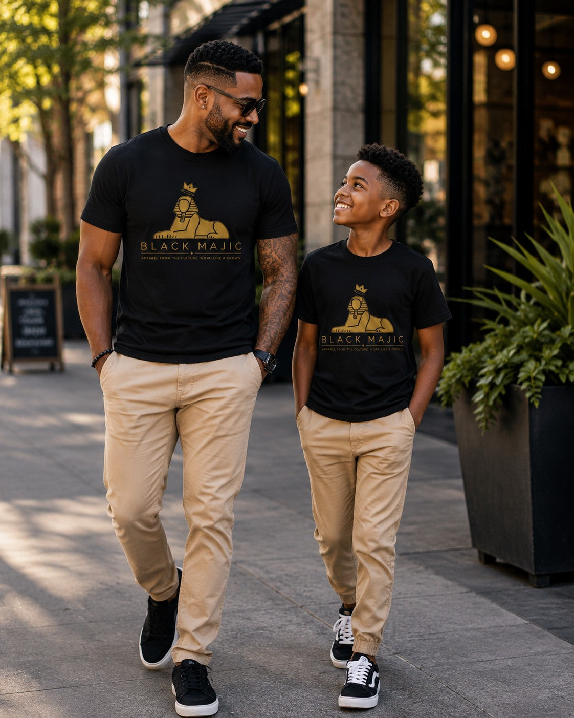 Father and son in matching black BLACK MAJIC Crown Graphic Tees