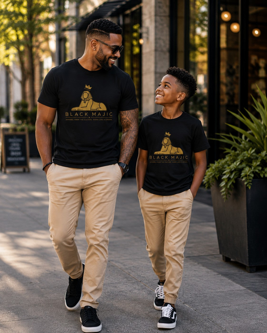 Father and son in matching black BLACK MAJIC Crown Graphic Tees