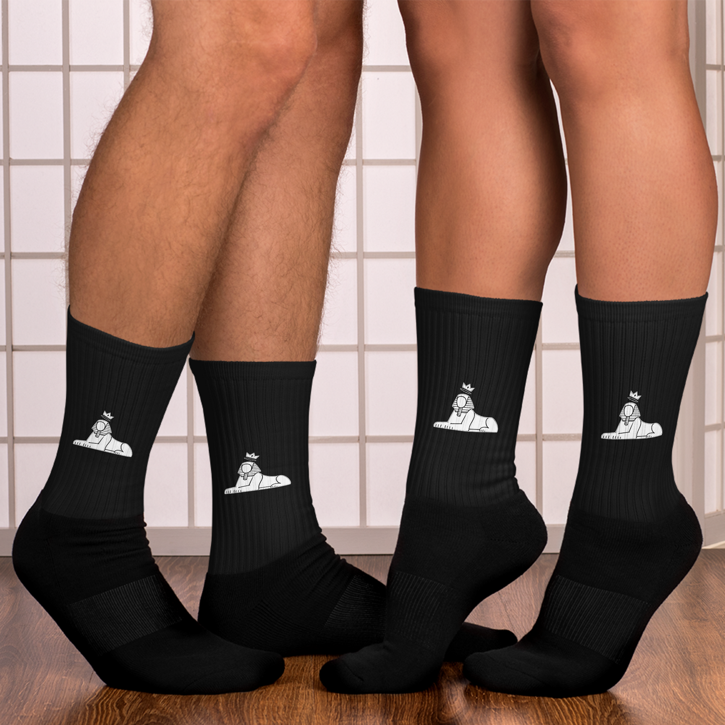 Two people wearing BLACK MAJIC Crown Socks in black against a tiled wall