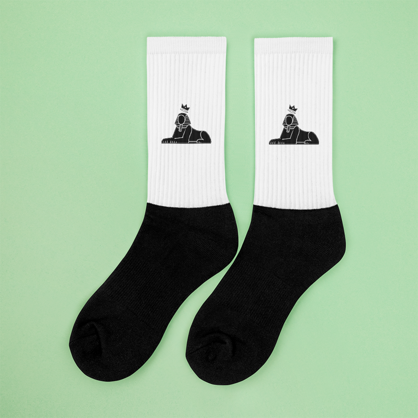 BLACK MAJIC Crown Socks in white with black foot, sphinx mark, flat-lay on mint