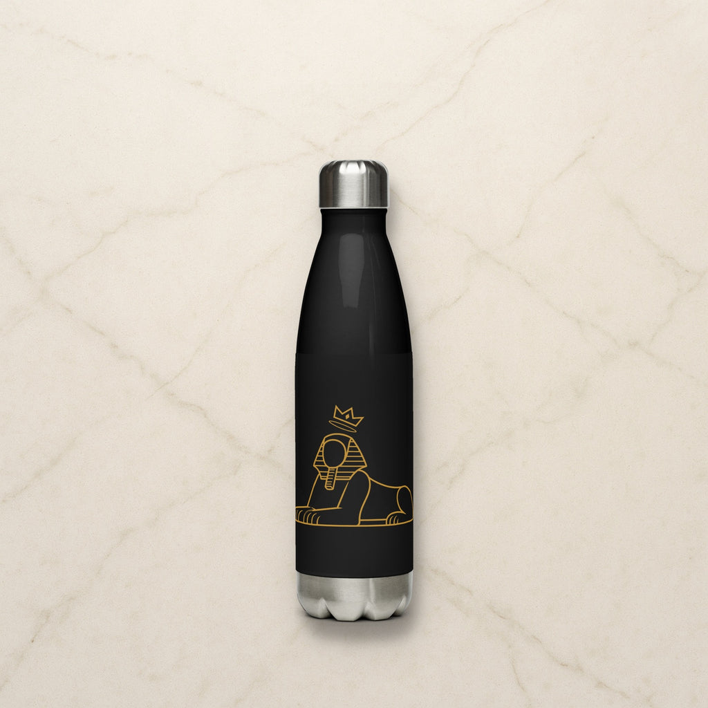 BLACK MAJIC 17 oz stainless steel bottle in black with the gold crowned Sphinx, on a pale marble counter