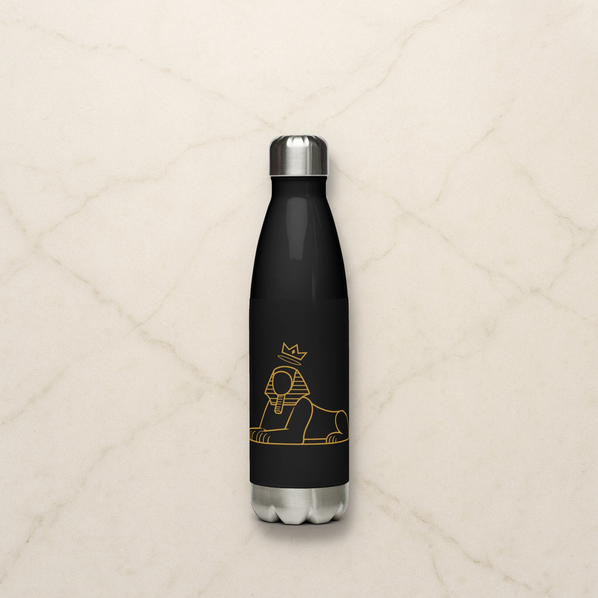 BLACK MAJIC 17 oz stainless steel bottle in black with the gold crowned Sphinx, on a pale marble counter