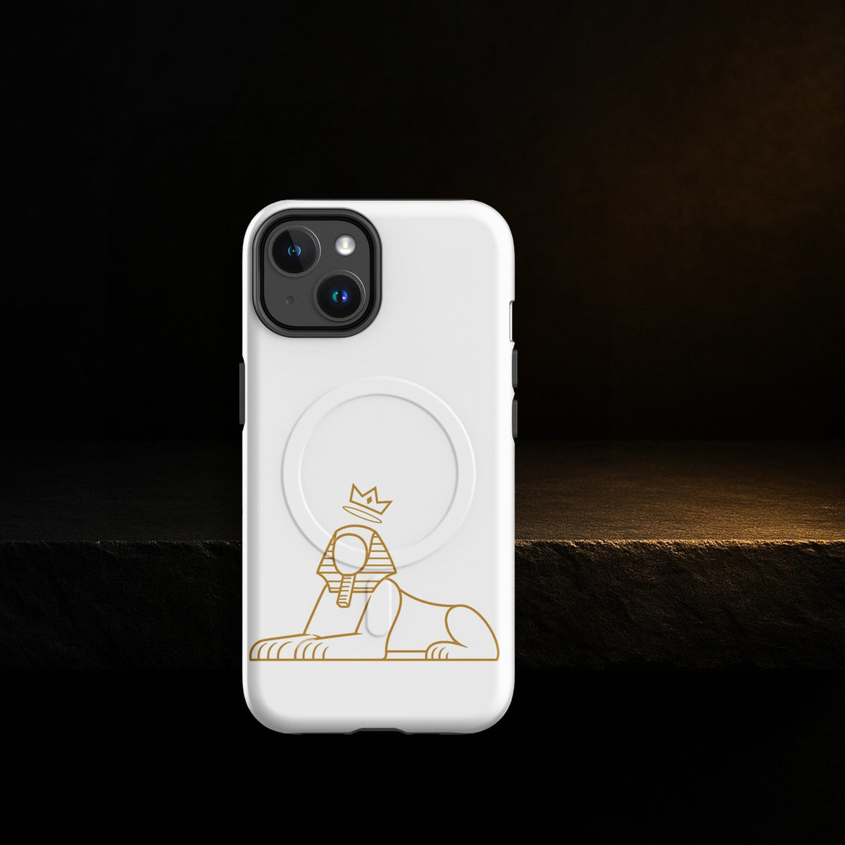 BLACK MAJIC MagSafe Tough Case in white with the gold crowned Sphinx, on a dark stone ledge