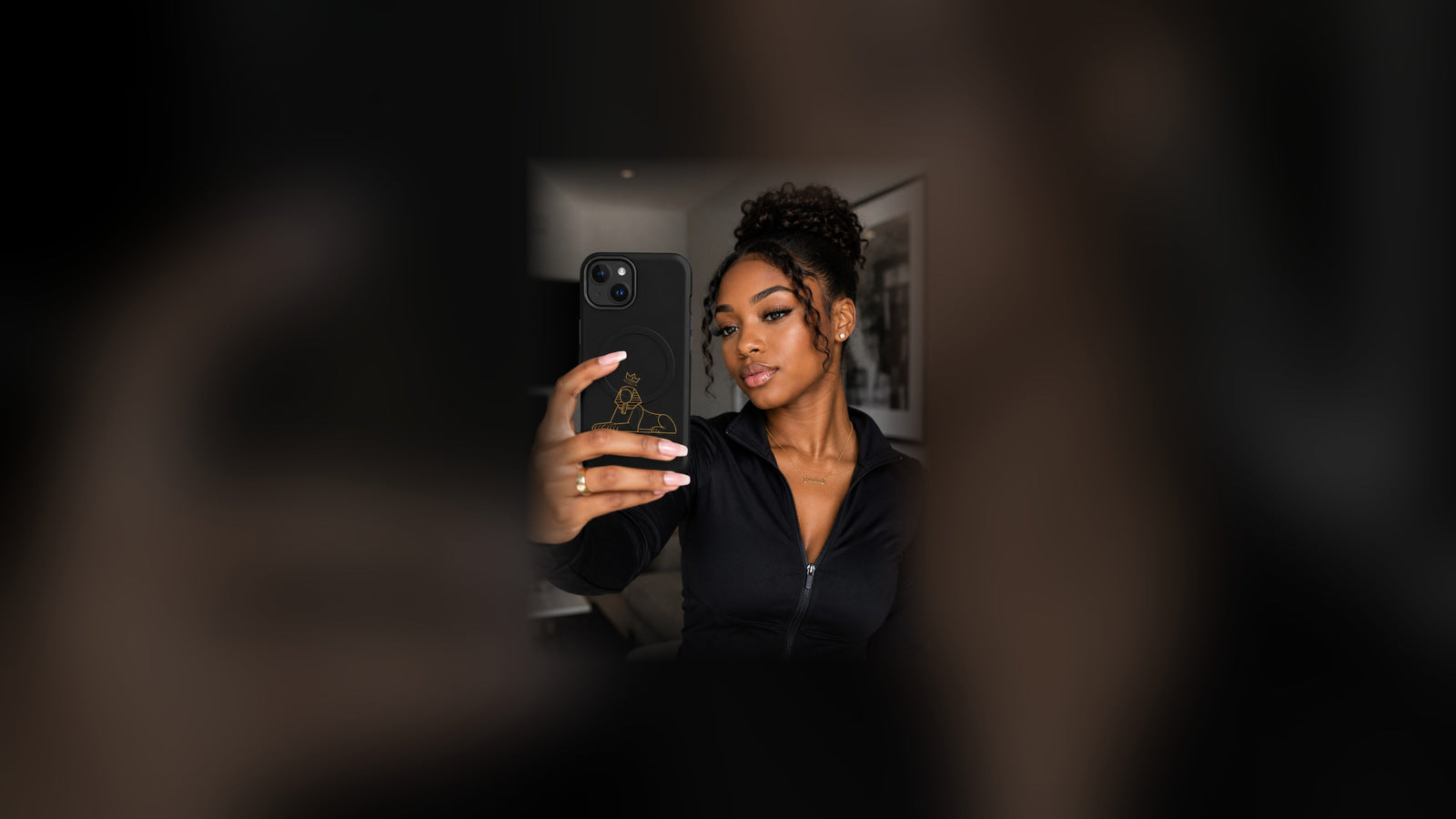 Accessories — Black woman holding the BLACK MAJIC MagSafe case in black