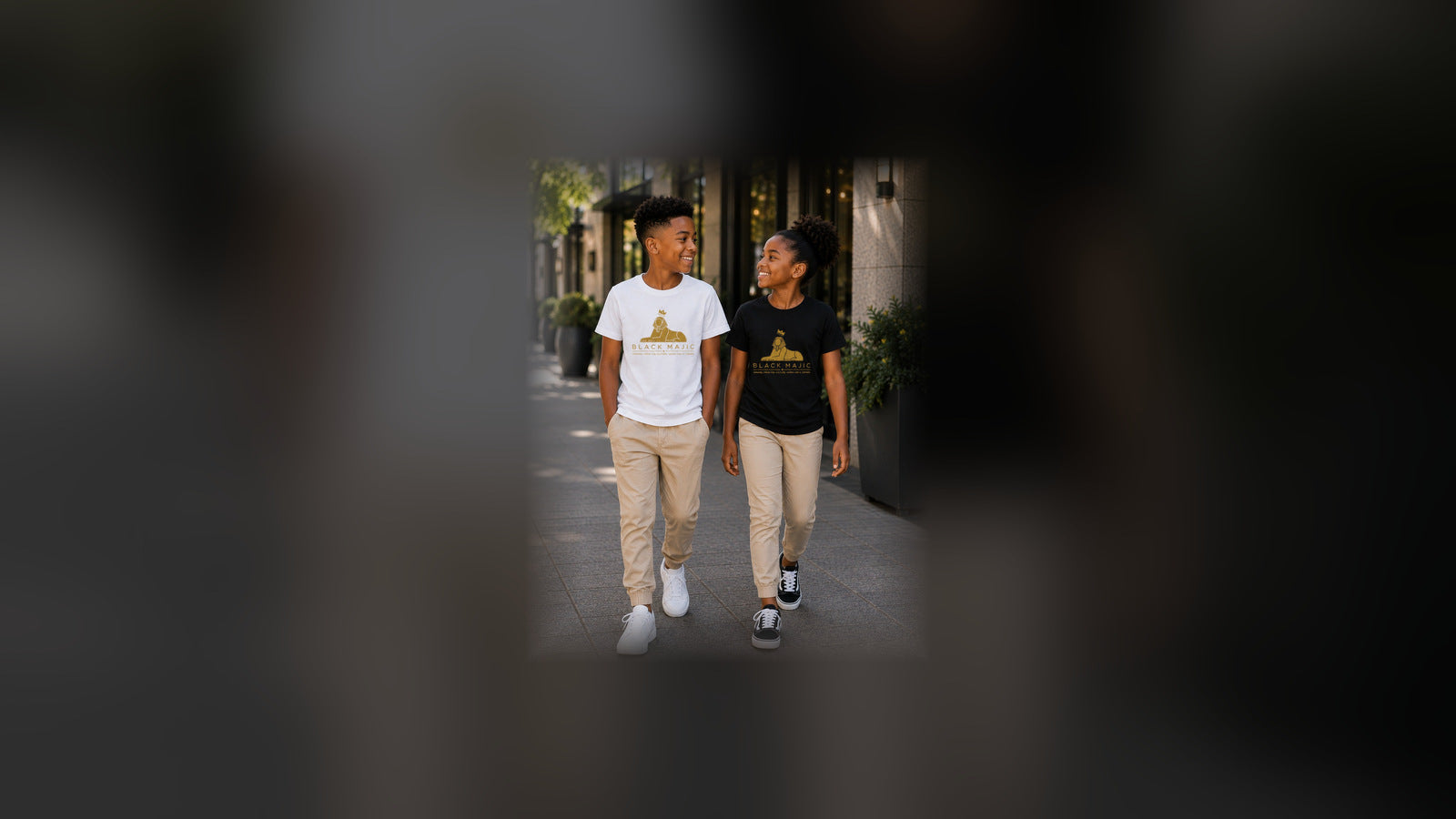 Kids — two Black children walking in BLACK MAJIC Crown Graphic Tees