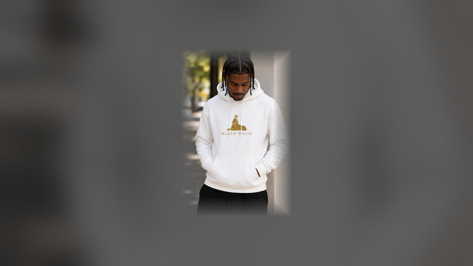 Men's — Black man in the BLACK MAJIC Crown Hoodie in white, gold crowned Sphinx