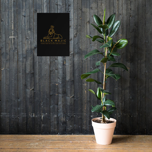 The Crown Poster 18×24 leaning against a dark wood wall — gold crowned Sphinx on black