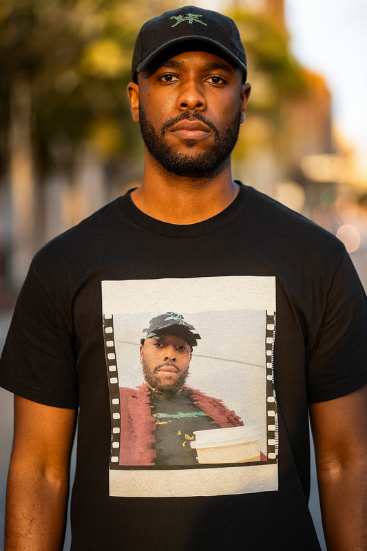 Black man wearing the Summer Static Snapshot Tee, film-strip print on black